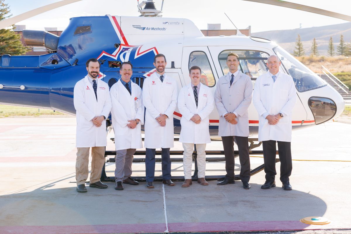 medical professional in front of a helicopter